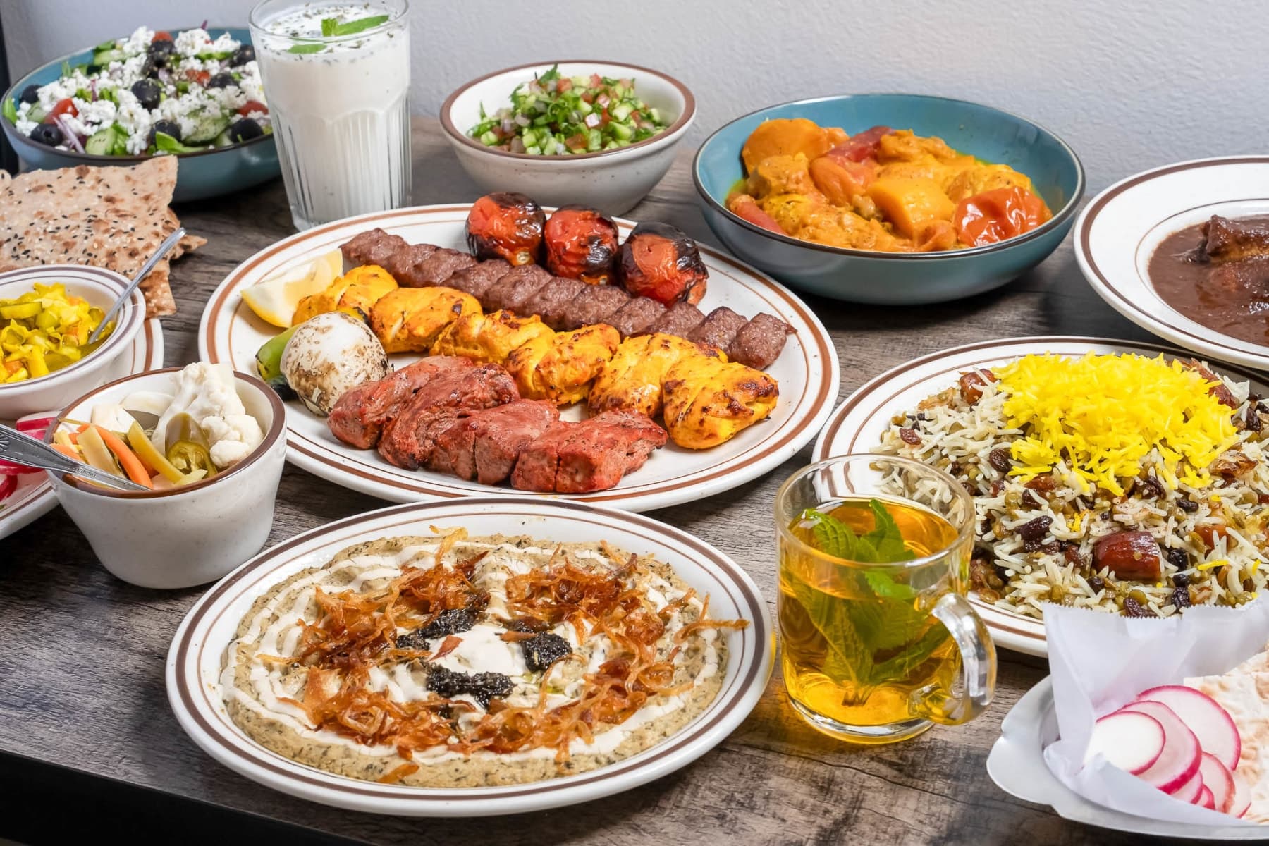Detail shot of Persian grilled meats and accompaniments